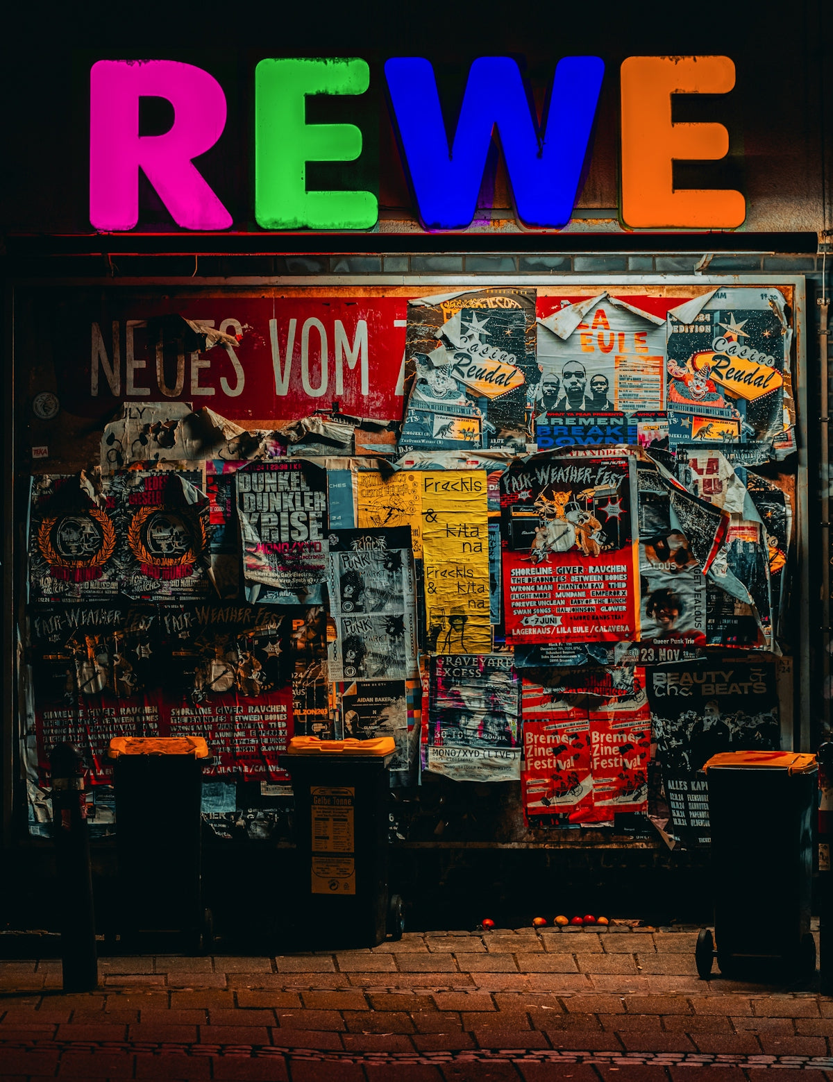 A store front with a neon sign above it
